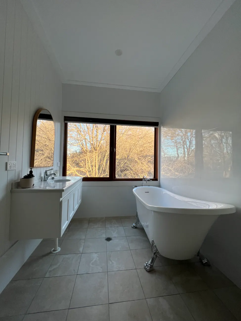 Country bathroom with clawfoot bath and garden windows