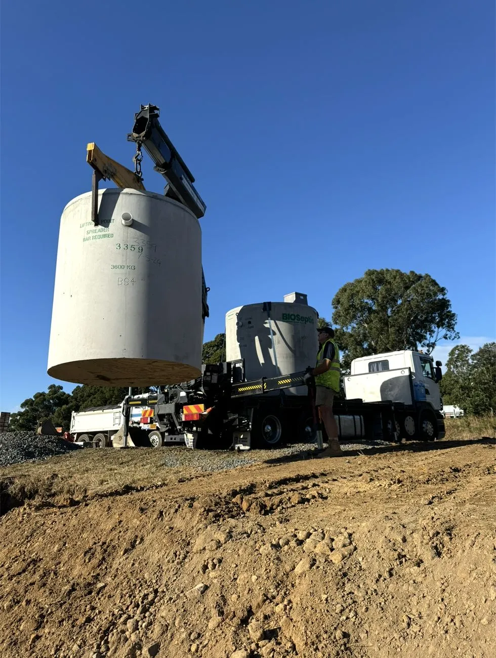 New septic tank being craned into place on a rural block