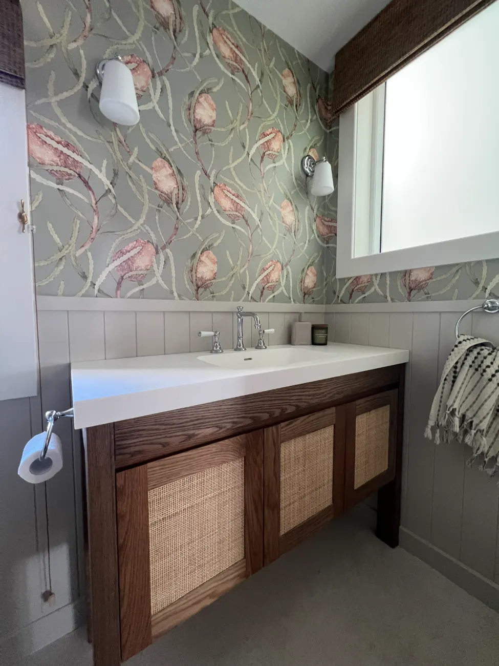 Vanity with botanical wallpaper and wall lights